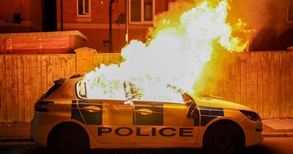 police van ablaze by rioters in Britain 